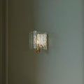 Wrought iron arm supporting textured glass panels on Duvernell Wall Sconce close-up