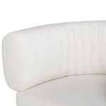 Close-up of Reina Accent Chair's left armrest and tufted backrest with smooth white upholstery