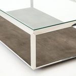 Close-up angled view showing glass top, steel frame, and detailed faux shagreen resin base