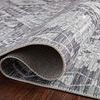 Partially rolled corner showing backside weave and thin low-pile structure of Zion Charcoal Slate rug