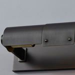 Close-up of brushed distressed bronze finish and rivet details on shade