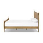 Side profile focusing on spindle leg and profile of woven paper cord headboard of Richard Bed