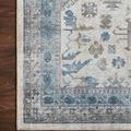 Close crop of rug edge showing detailed pattern and placement on dark wood floor