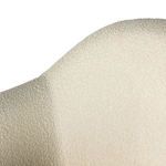 Close-up detail of curved backrest upholstery with consistent boucle texture