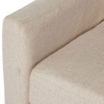 Close-up of seat cushion thickness and upholstery folds along the base of the slipcover