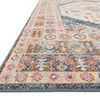 Low angle close-up showing thick textured pile and detailed multi-color border of vintage style rug