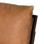 Three-quarter view of Elias Cane Accent Chair showing leather cushions and dark metal base