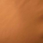 Close-up texture of smooth tan top-grain leather cushion