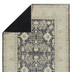 Top corner flipped to reveal solid black rug backing of Pia Medallion rug