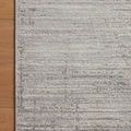 Partial rug view placed on a wooden floor highlighting the rug’s soft texture and border stitching