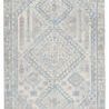 Light blue and gray handwoven rug with geometric medallion pattern and tribal-inspired details