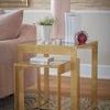 Plano Side Tables styled with pink lamp, plant, and books beside a pink couch on patterned rug