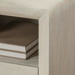 Close-up of drawer front partially open revealing dark stained wood interior and metal runners