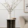 Terrell End Table in modern setting with vase and books, positioned beside soft curved sofa