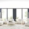 Complete Nest Modular Sectional configuration in bright room with two black shelves and natural rug