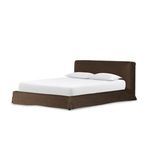 Side view of queen bed with brown linen slipcover and white mattress, pillows at headboard