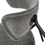 Close-up of textured grey tweed fabric and black metal frame connection on backrest