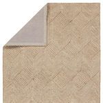 Backside corner folded to reveal neutral fabric backing and binding on Castellan 9x12 rug