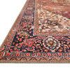 Close-up of Loren rug corner showing navy border with floral motifs and beige edge stitching