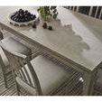 Close-up angled view of Coalesce Rectangular Dining Table top with decorative bowl and scattered fruit on textured surface