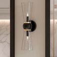 Byford Bath Wall Sconce mounted on wall with marble backsplash and dark framed mirror in bathroom