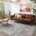 Zion Grey / Multi Rug styled in modern living room with brown leather sofa and natural light.