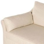 Close detail of a long rectangular accent pillow and back cushion on corner section