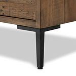 Dark stained dresser top corner showcasing plank arrangement and matte black iron handle