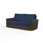 Montecito Loveseat outdoor sofa with cognac resin wicker frame and navy blue cushions