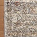 Corner of rug laid on wooden floor highlighting pattern detail and color contrasts