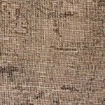 Zoomed section of rustic vintage rug pattern with soft tonal transitions and natural fibers