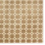 Detail close-up showing woven wool texture and muted sage accents of Japera rug pattern