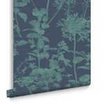 Rolled wallpaper against white background showing scale and pattern repeat