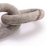 Close-up of connected oval links featuring natural marble veins and soft matte finish