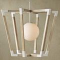 Pendant illuminated against textured beige wall showing warm light through frosted globe