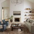 Living room with vaulted ceiling, featuring the Lyra rug under a wooden coffee table and neutral-toned sofa