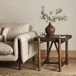 Living room context showing table beside upholstered sofa on hardwood floor
