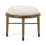 Back view of ottoman showcasing iron stretcher and wood grain on frame