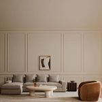 Wide view of neutral living room with Thomas sectional, beige walls, and modern décor accents