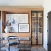 Augustus Denim Rug styled in a modern home office with wooden cabinet, black metal desk, and artwork