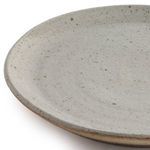 Close-up of natural speckled surface and textured rim of dinner plate showing subtle variations