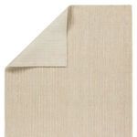 Corner view showing rug backing in solid light beige fabric