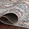Close-up of rug folded to reveal tightly woven backing and flat pile surface