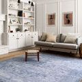 Loren Slate Rug styled in a bright living room with grey sofa and white built-in shelves