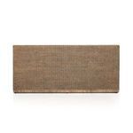 Close-up showing texture of rattan weave and cushion fabric on bench back
