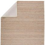 Rosier rug corner flipped to reveal soft beige fabric backing