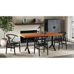 Three black Ventana dining chairs around rectangular wooden table in bright living space with fireplace