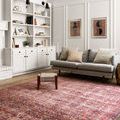 Loren rug styled in living room with grey sofa, white bookshelf, and wooden floor
