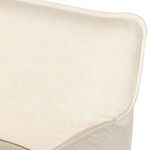 Close-up of armchair back corner showing linen fabric weave and neat stitched edges