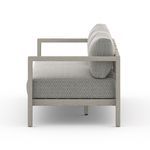 Side profile of sofa showing depth of cushions and ash wood armrest detail
